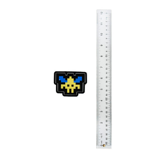 invader sticker next to ruler for scale