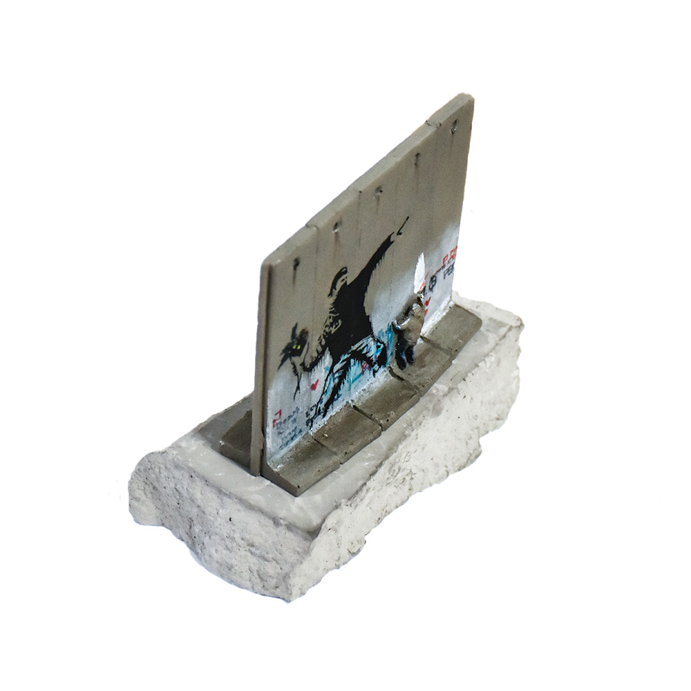 side view of banksy walled off hotel flower thrower wall sculpture