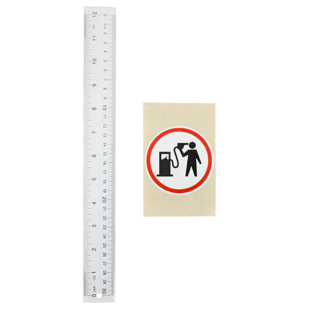 banksy petrolhead round sticker next to ruler