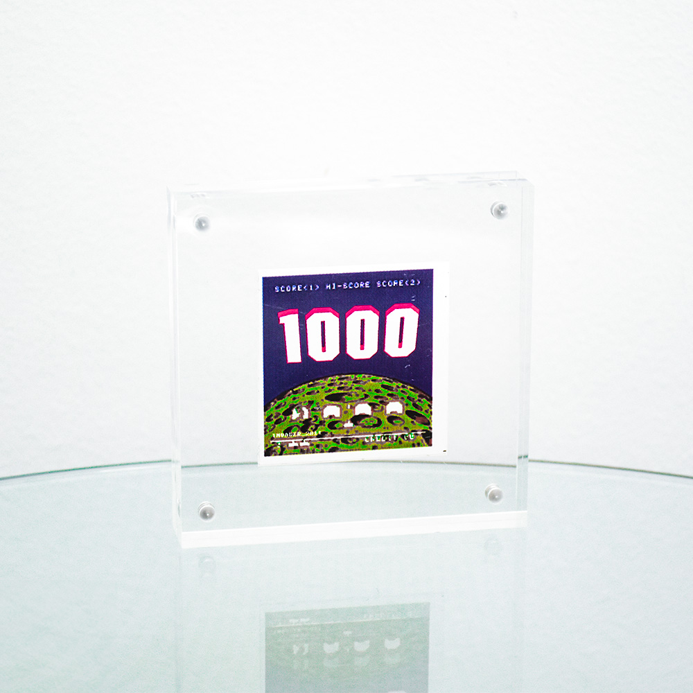 invader high score sticker in clear frame.