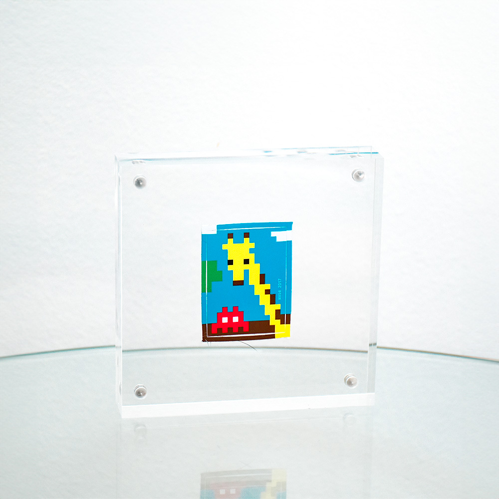 invader with giraffe sticker in clear frame.