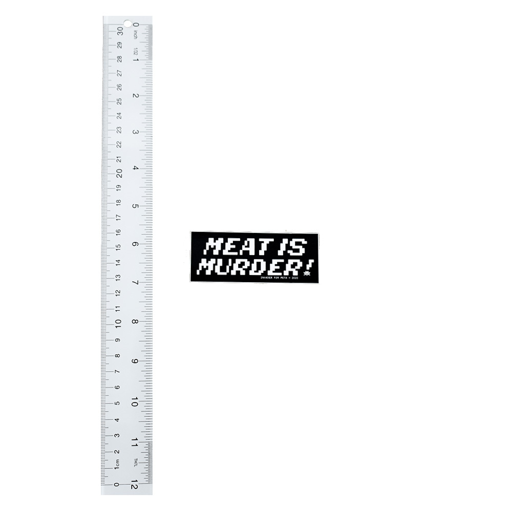 invader peta meat is murder sticker next to ruler